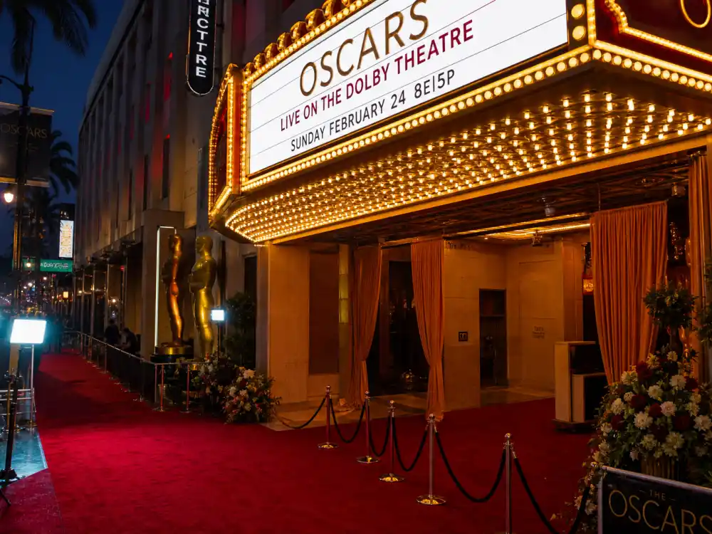 Theatre marquee lights glow before nights when the best award show hosts of all time step onto major ceremony stages across Hollywood