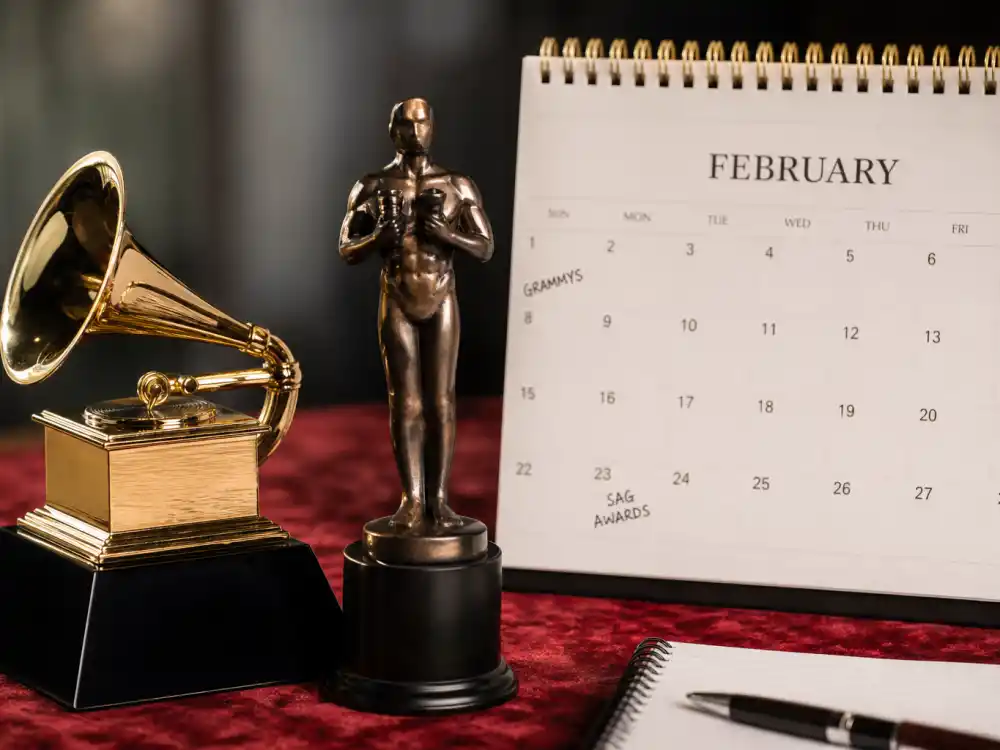 Grammy gramophone and SAG actor statuettes on desk with February calendar for awards season 2027 calendar all dates music and guild nights