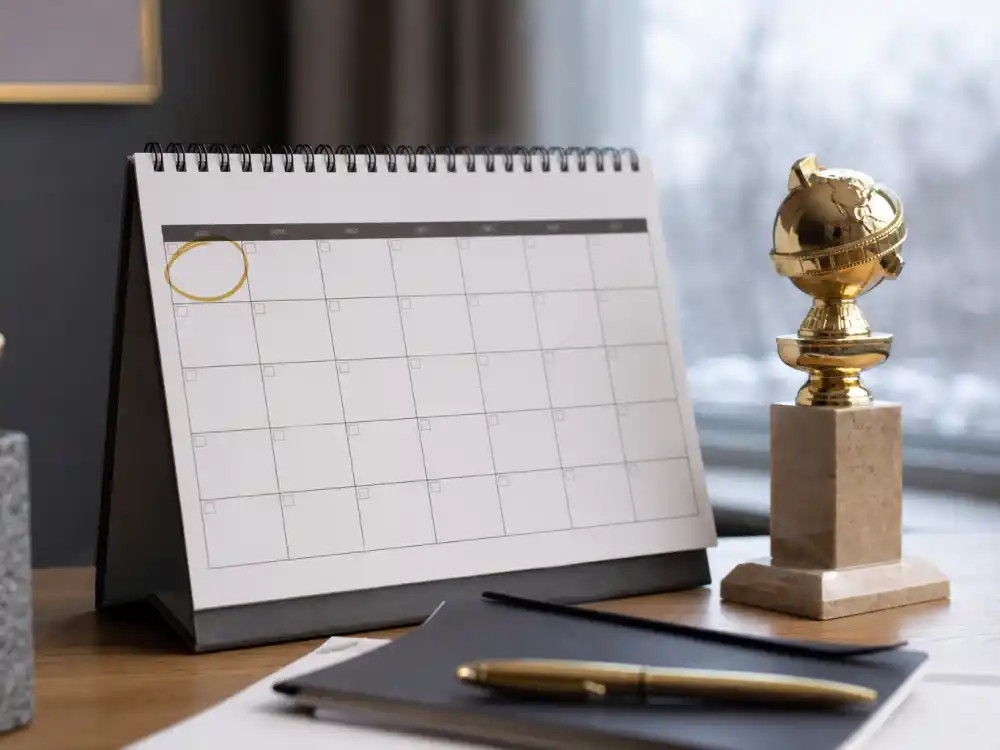 January wall calendar with golden globe trophy on desk for awards season 2027 calendar all dates winter kickoff planning