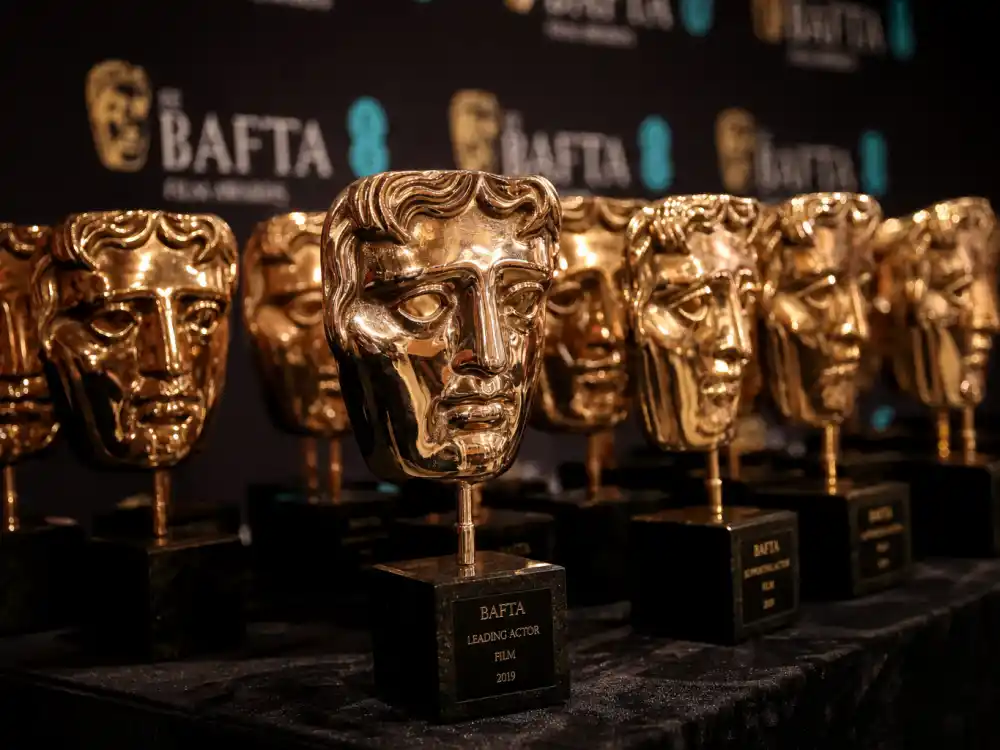 Golden BAFTA mask trophies displayed at the BAFTA Awards 2026 winners list press room where One Battle After Another and Hamnet claimed top honors
