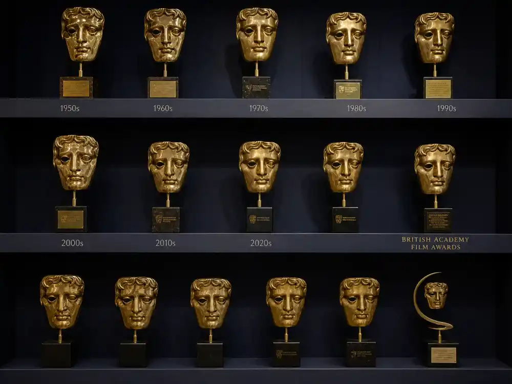 Golden BAFTA mask trophies on display representing two decades of BAFTA Rising Star Award winners list history since James McAvoy in 2006