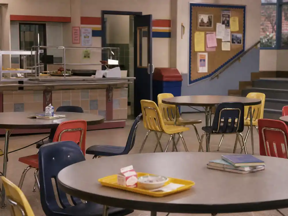 A 1990s high school cafeteria evoking Ben Savage as Cory Matthews on Boy Meets World teen sitcom era