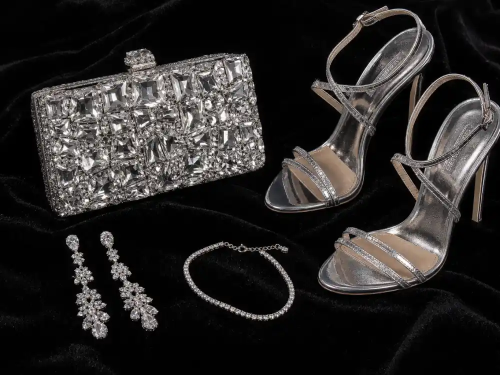 Diamond drop earrings crystal clutch strappy silver heels and bracelet flat lay completing accessory stacking rules for best dressed celebrities 2026 red carpet finishing touches