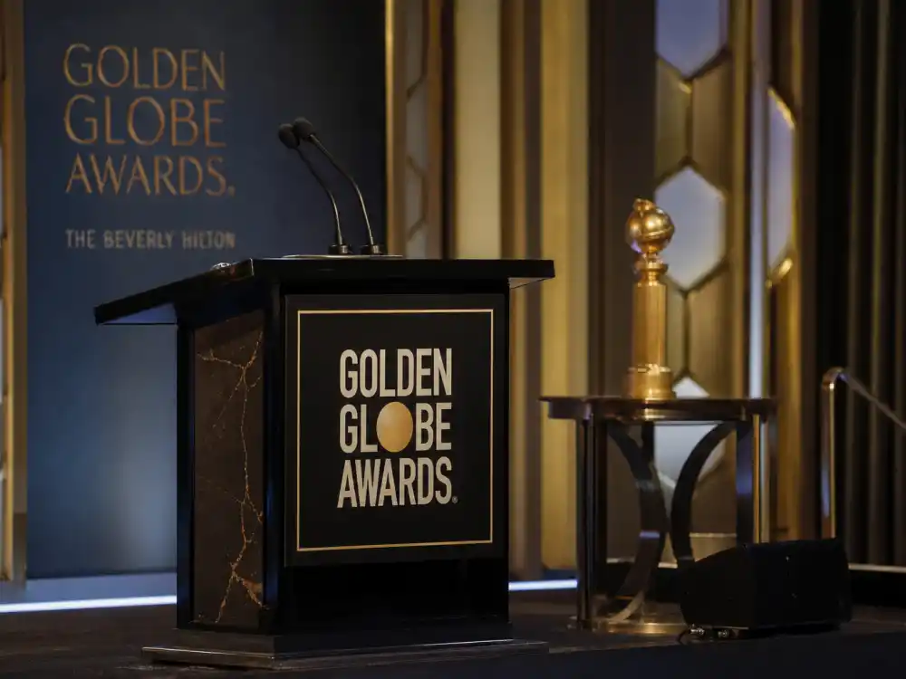 Dual microphones on a Golden Globes lectern where the best Golden Globes host monologues ever have opened NBC telecasts for decades