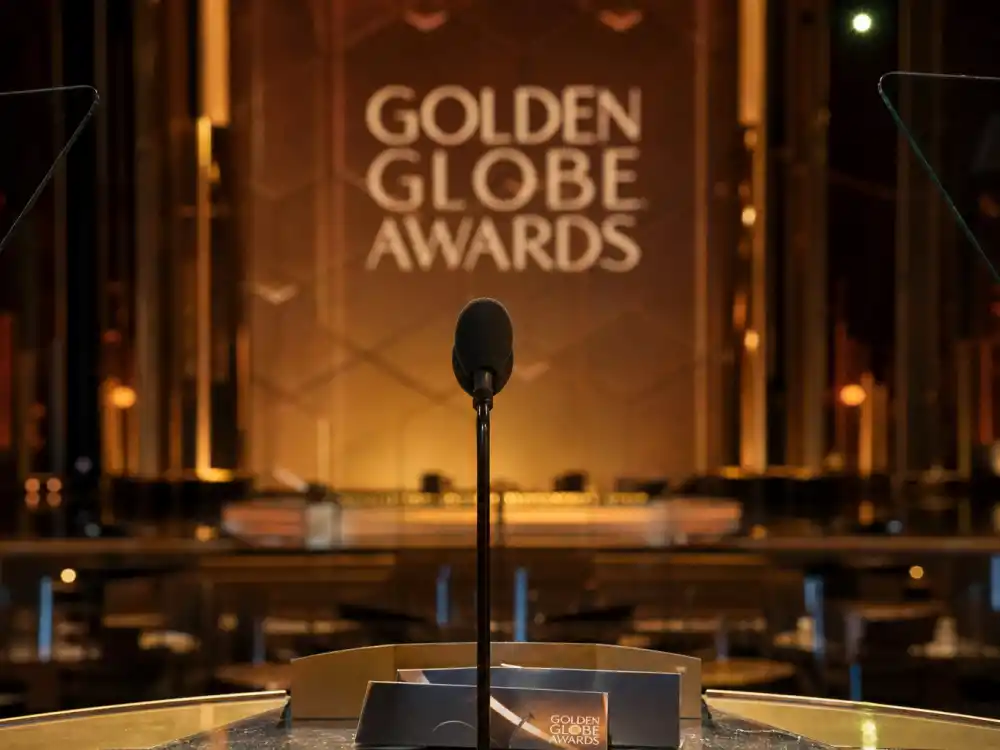 Spotlit podium microphone during opening monologue moments ranked among the best Golden Globes host monologues ever on NBC