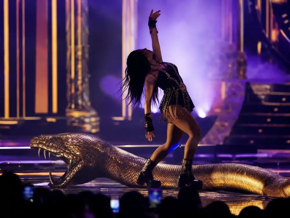 Britney Spears snake dance VMA performance remains a staple of the best VMA performances of all time ranked lists with gold and purple stage lighting