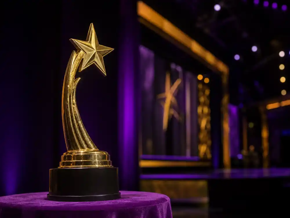 Golden lifetime achievement trophy on velvet pedestal symbolizing every name on the BET Lifetime Achievement Award winners roll call