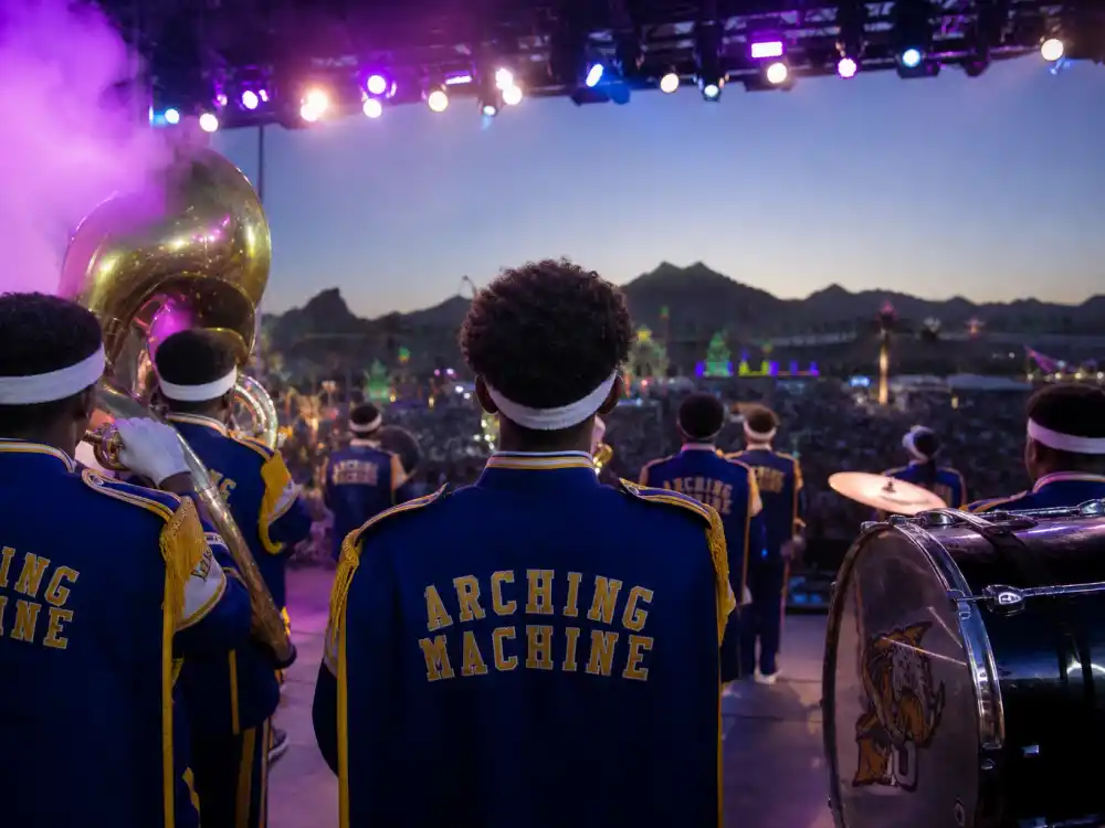 HBCU-style marching band silhouettes on festival stage in Beyonce Coachella kids cameo explained — Beychella 2018 cultural backdrop documented by People and Us Weekly