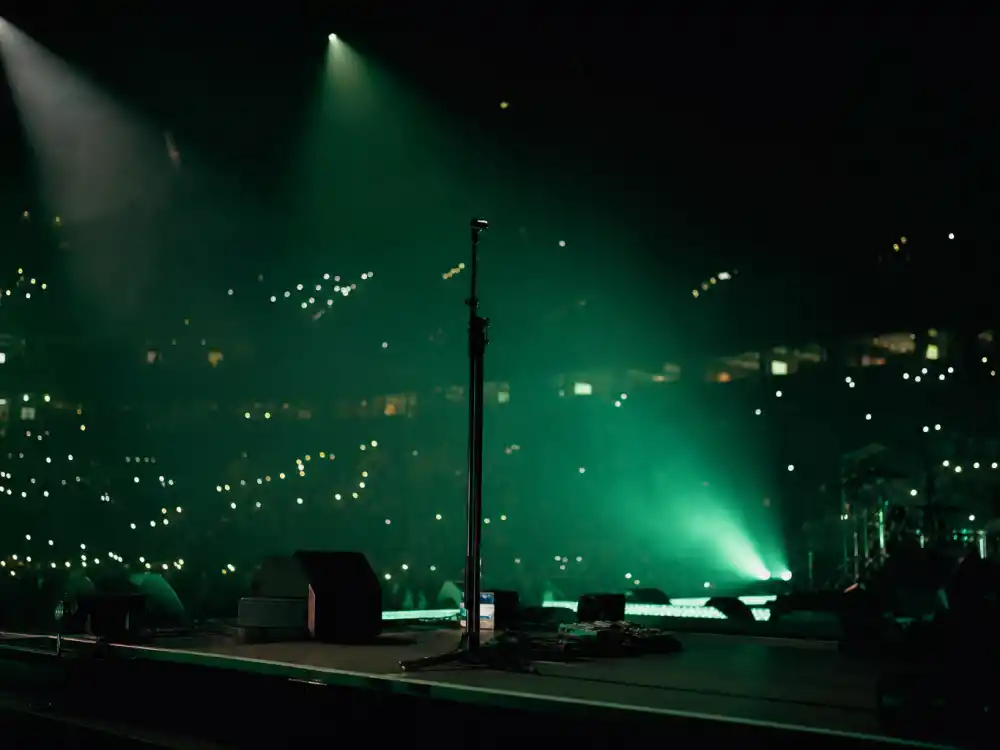 Arena concert stage reflecting Billie Eilish age and birthday 2026 touring milestones from bedroom recordings to stadium-scale headline runs in her twenties