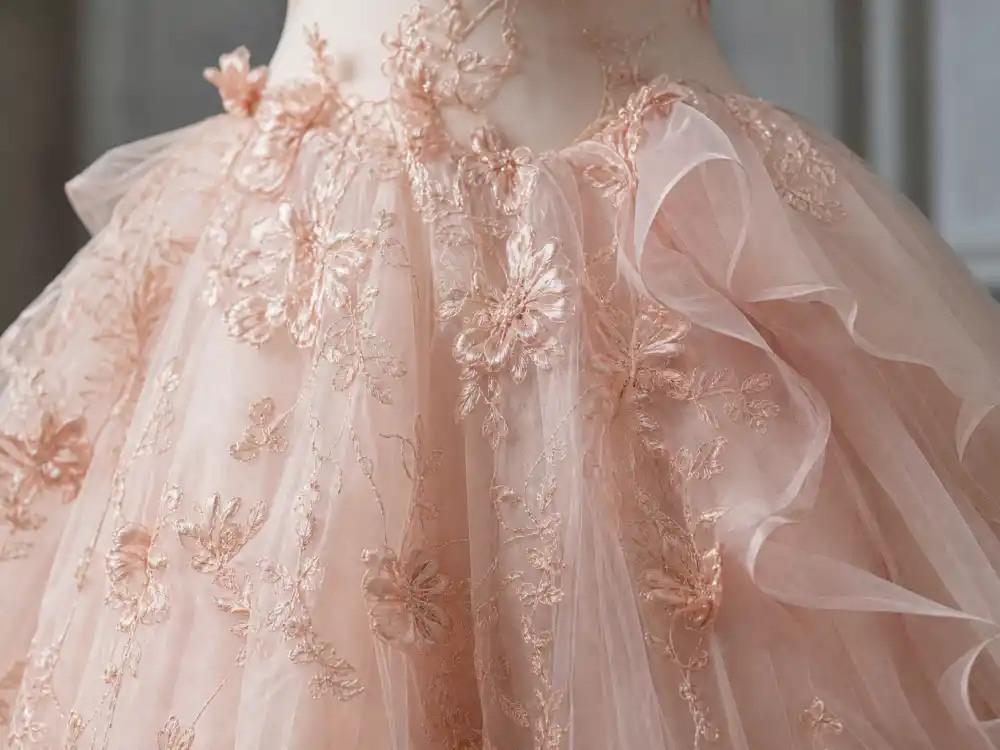 Blush pink champagne tulle layers and silk organza central to Blake Lively wedding dress Marchesa romantic ball gown construction
