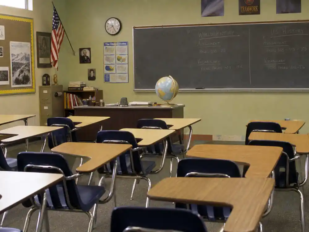 A classic 1990s classroom with desks and chalkboard representing the Boy Meets World cast where are they now sitcom school years