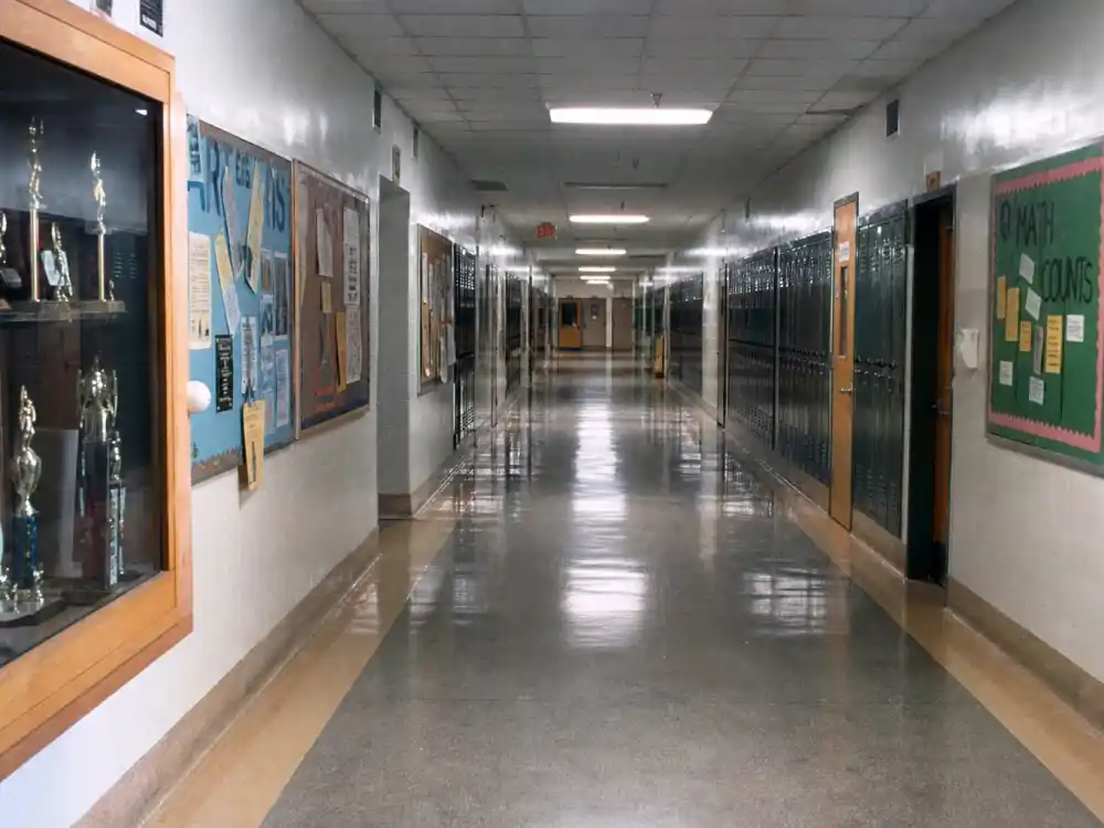 A 1990s suburban high school hallway evoking John Adams High and the Boy Meets World cast where are they now nostalgia
