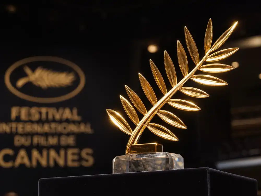 Golden Palme d'Or trophy on velvet pedestal symbolizing the top prize on the Cannes Film Festival 2026 winners list