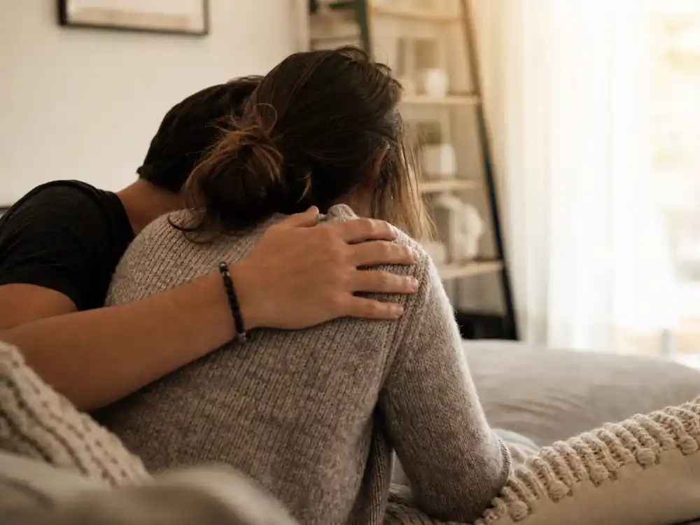Supportive partner silhouette comforting anonymous woman for celebrities open about IVF struggles — emotional fertility journey editorial without identifiable faces