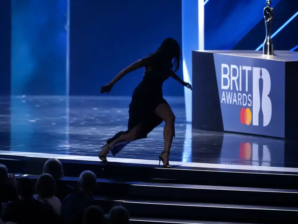 Anonymous formal silhouette stumbling on Brit Awards stairs recalls Adele heel trip among celebrities who fell on stage at award shows