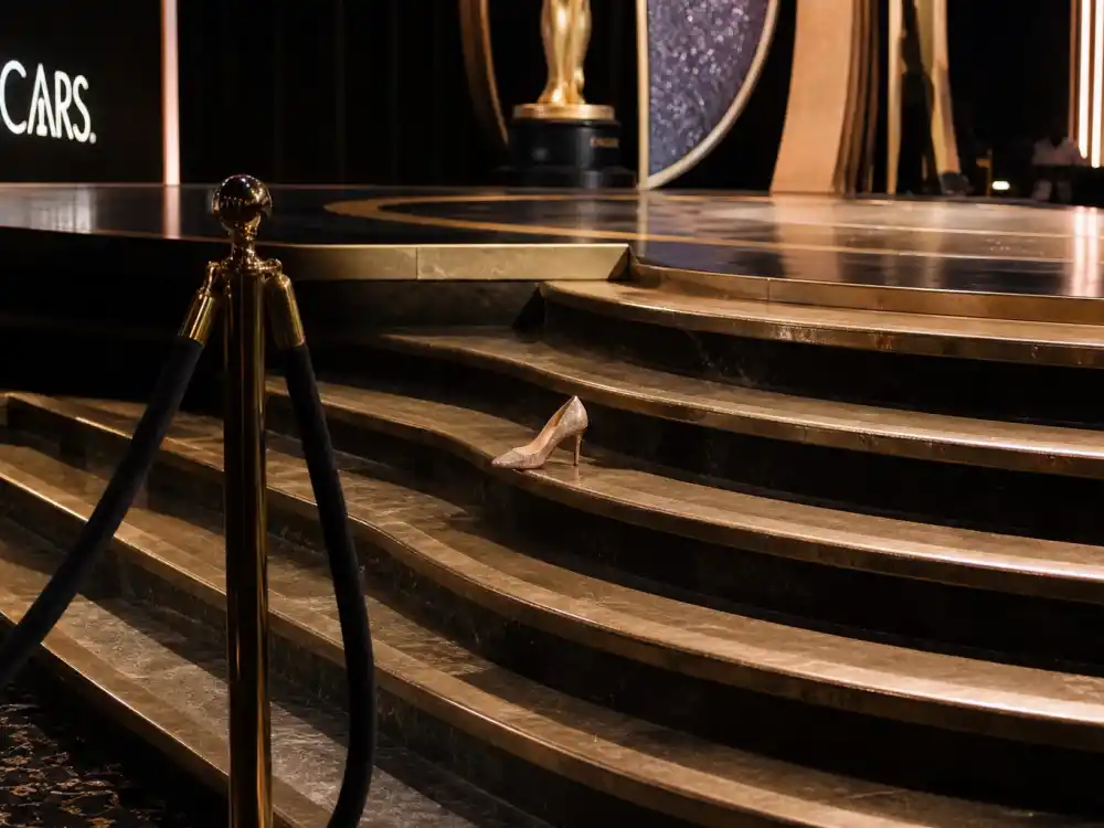 High heel on Oscar ceremony marble stairs symbolizes celebrities who fell on stage at award shows on live Academy Awards telecasts