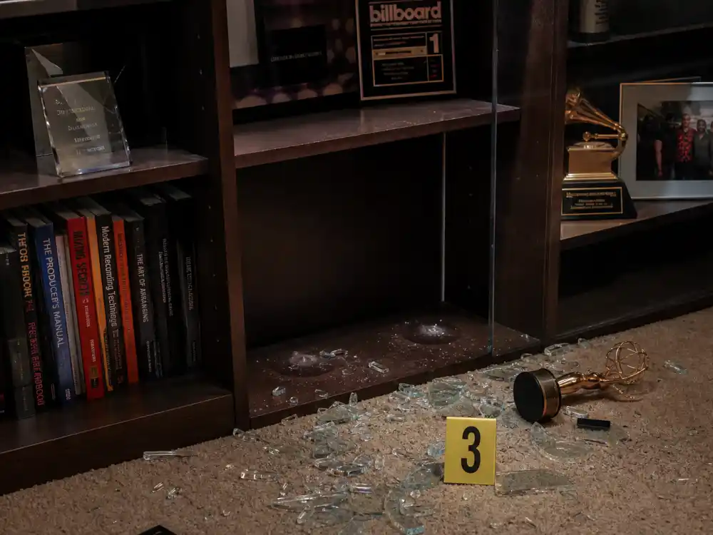 Burglarized home trophy shelf with empty Grammy and Emmy mounts for celebrities who lost their award trophies music and television section