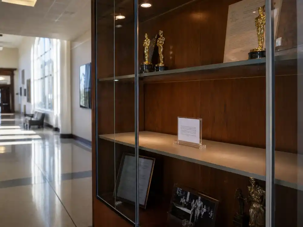 University fine arts hallway with empty glass trophy case for celebrities who lost their award trophies Howard University chapter