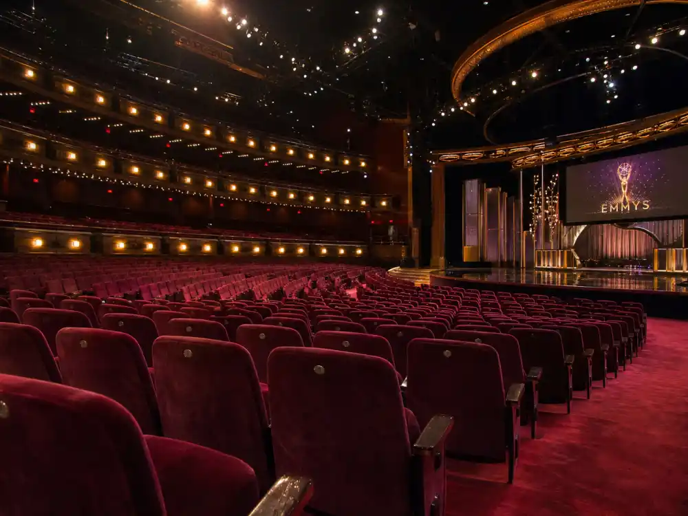 Rows of empty awards theater seats represent no-shows and celebrities who refused or declined awards across Oscar, Grammy, and Rock Hall ceremonies