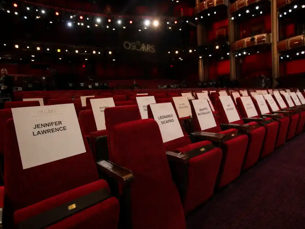Rows of empty awards theater seats represent no-shows and celebrities who skipped accepting their awards across Oscar, Grammy, and Emmy ceremonies