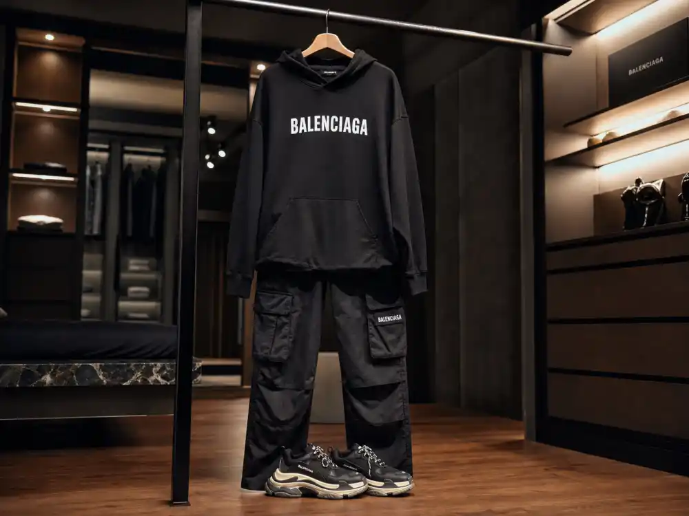 Balenciaga streetwear outfit with oversized logo hoodie and chunky sneakers on hanger showing off-duty dressing codes celebrities who wear Balenciaga use between premieres