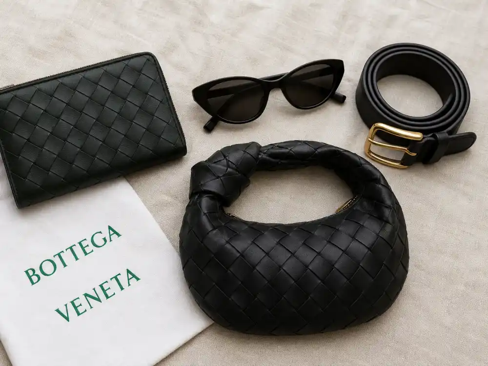 Bottega Veneta intrecciato wallet sunglasses belt and mini Jodie hobo bag flat lay capturing accessory stacking rules celebrities who wear Bottega Veneta layer with tailoring and evening columns