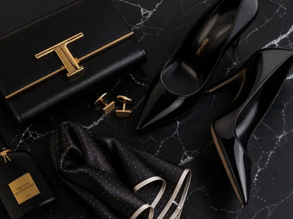Luxury heels clutch cufflinks and silk pocket square flat lay completing celebrities who wear Tom Ford accessory finishing rules