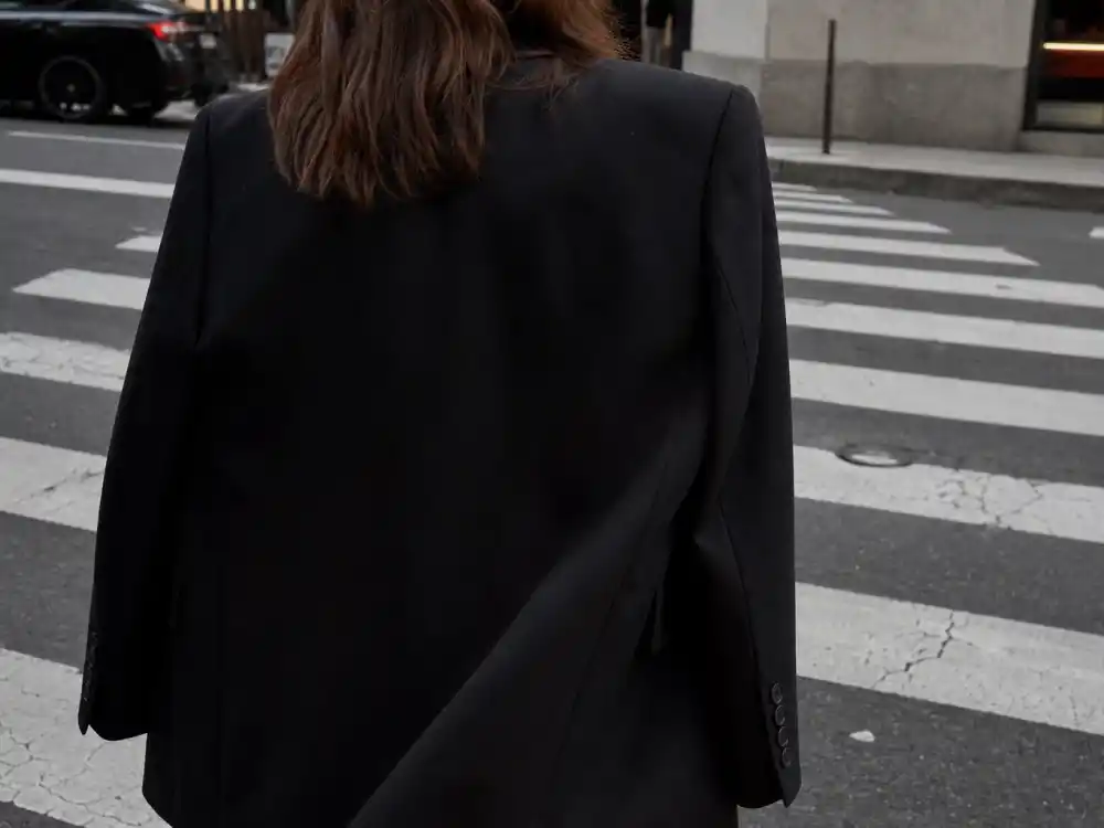 Oversized black wool blazer with structured shoulders central to celebrity blazer street style outfits power-shoulder sidewalk codes