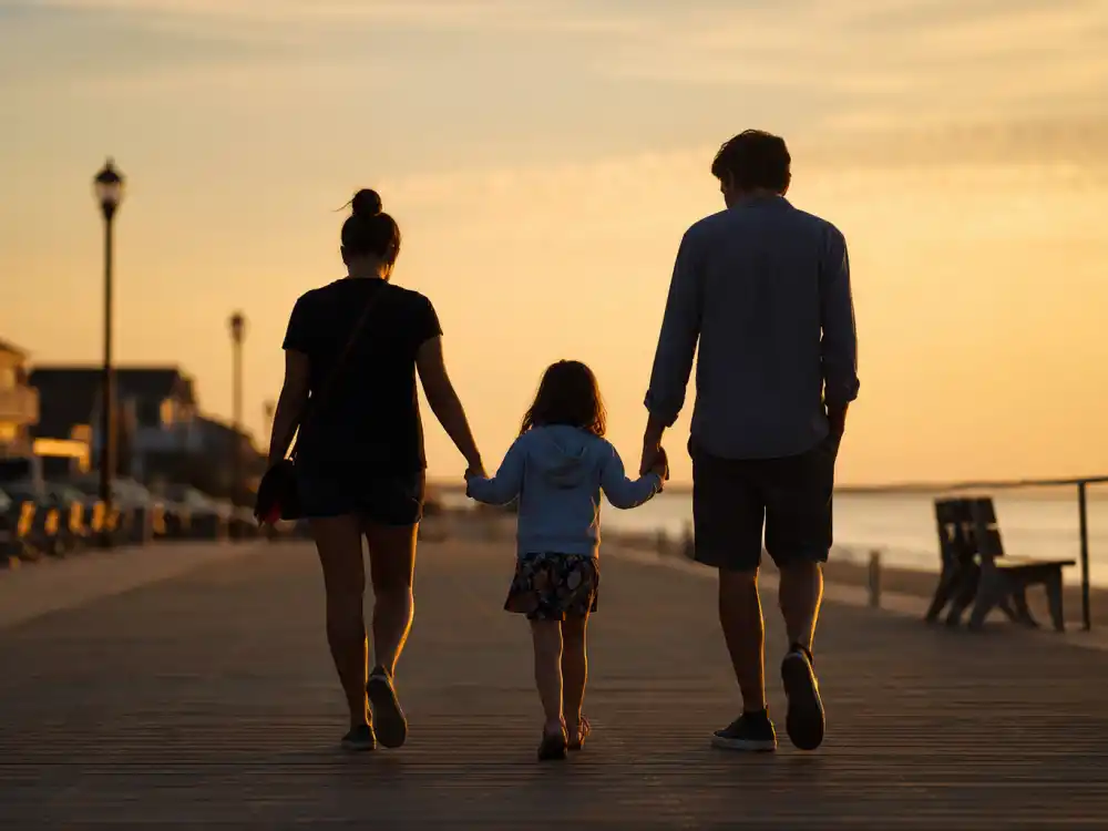 Beach boardwalk co-parent outing silhouettes for celebrity co-parenting success stories 2026 Orlando Bloom Katy Perry Miranda Kerr Flynn lane editorial without identifiable faces