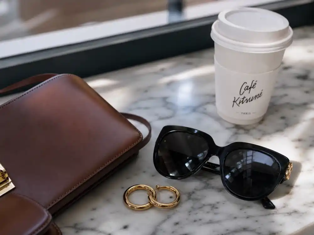 Oversized sunglasses gold hoops and crossbody bag finishing celebrity coffee run outfits street style accessory layer