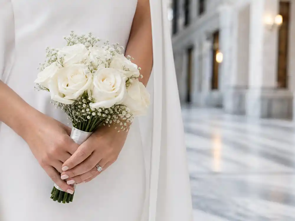 Minimal white rose bouquet detail central to celebrity courthouse wedding outfits simple elegant civil ceremony styling