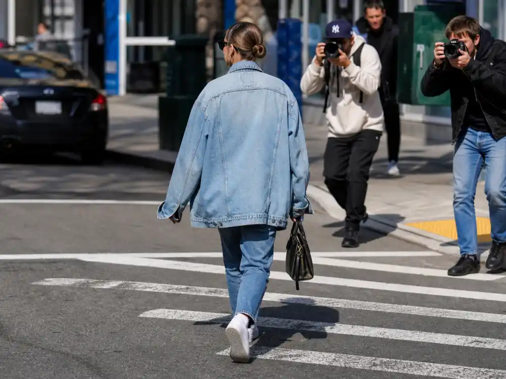 Double denim jacket and jeans defining celebrity denim street style looks contrast dressing on urban crosswalks