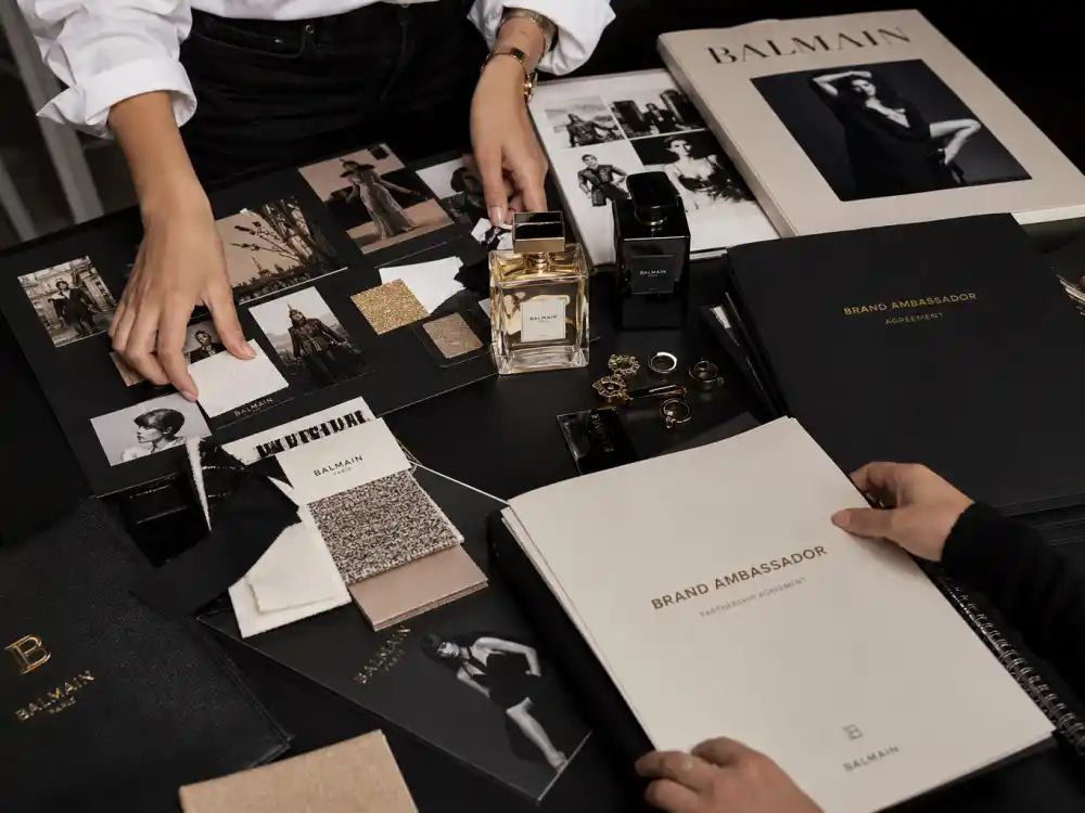 Fashion studio campaign desk with mood boards and brand ambassador contracts illustrating how celebrity designer brand ambassadors 2026 deals get planned