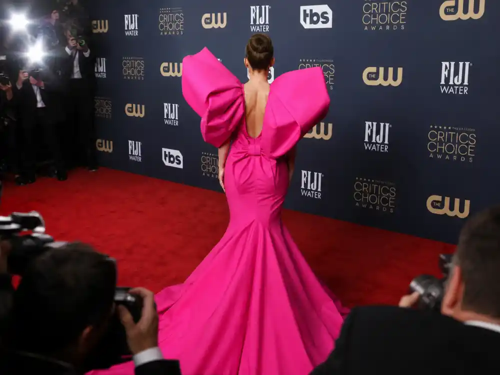 Anonymous woman from behind in bold pink architectural gown at awards step-and-repeat defining celebrity fashion moments that broke the internet red carpet shock value