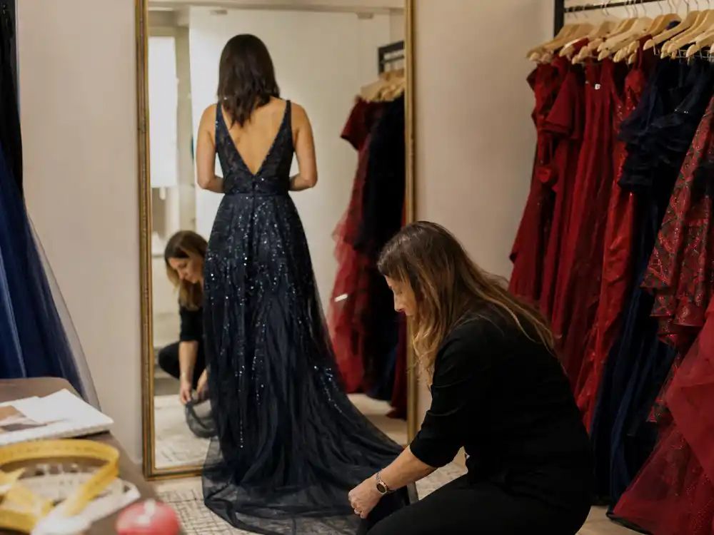 Fitting room celebrity get the look stylist tips with stylist pinning evening gown hem on anonymous client before red carpet call time