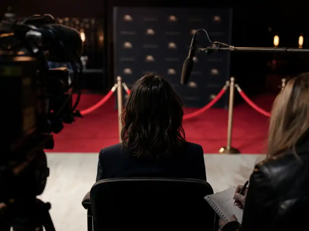Press interview setup from behind with microphone for celebrity kids rejecting nepo baby label verified quote context editorial without faces