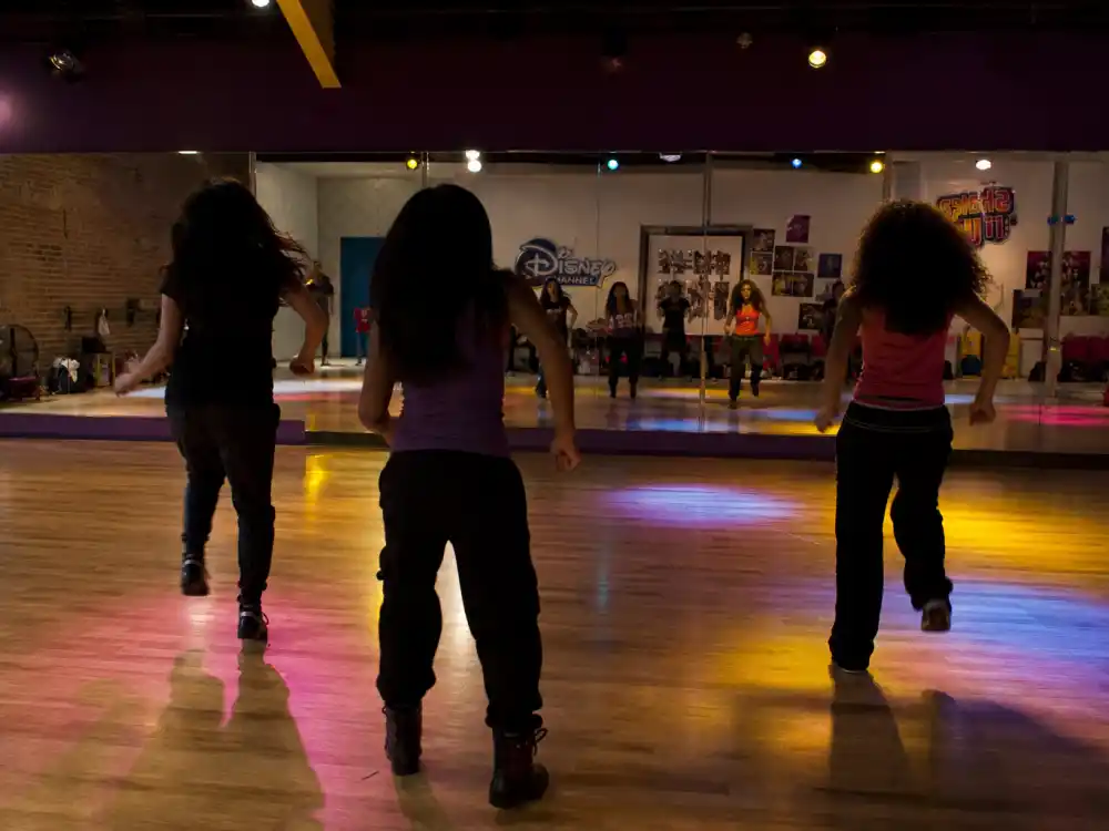 Shake It Up dance studio from behind for celebrity kids who started on Disney Channel teen comedy editorial without identifiable faces