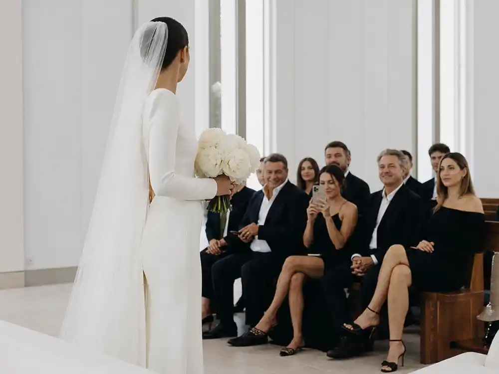 Modern chapel ceremony where celebrity minimalist wedding dress trends meet architectural light and clean crepe column silhouettes