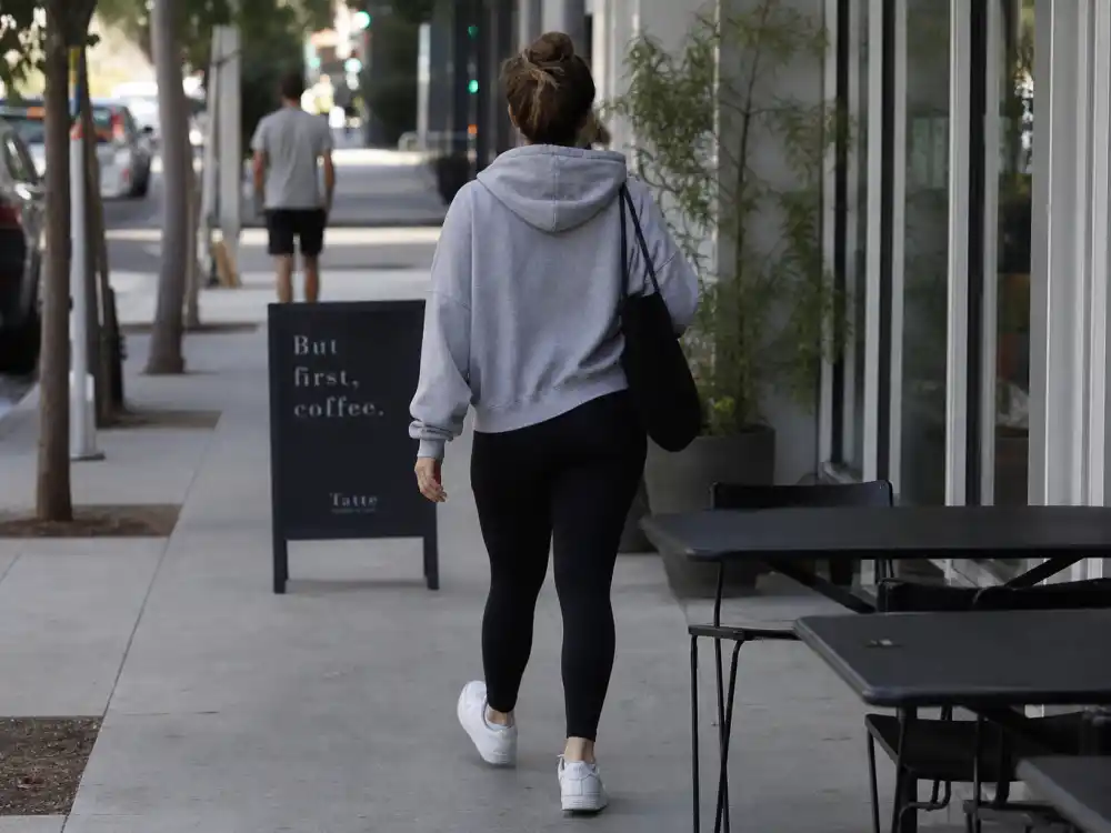 Oversized gray hoodie and black leggings illustrating celebrity model off duty outfits athleisure rotation
