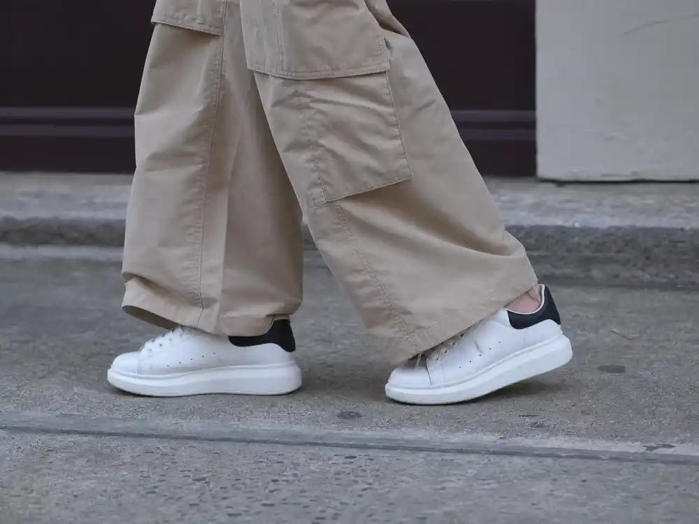 Clean white sneakers with wide-leg pants showing celebrity off duty street style guide footwear discipline