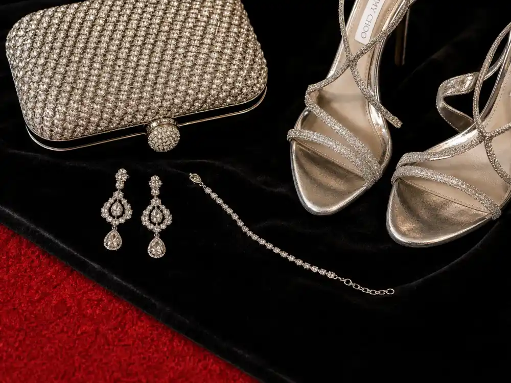 Diamond drop earrings crystal clutch strappy silver heels and bracelet flat lay completing accessory stacking rules for celebrity red carpet dresses 2026 premiere finishing touches
