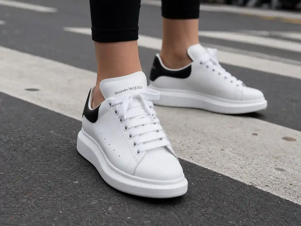 Pristine white leather sneakers on urban crosswalk central to celebrity sneaker street style outfits elevated casual footwear codes