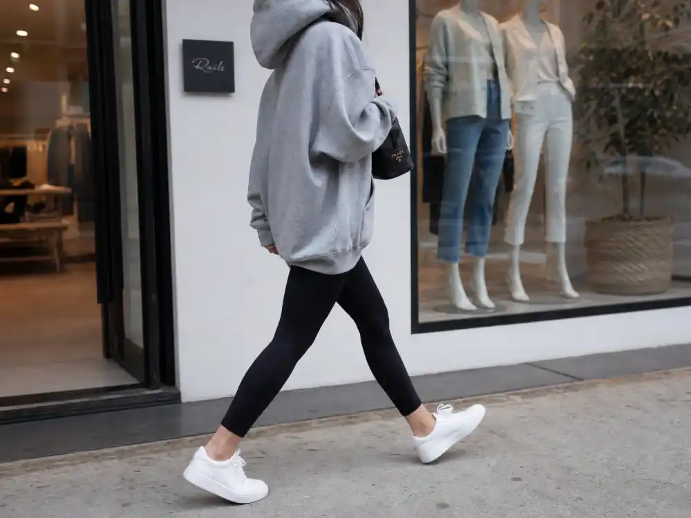 Black leggings white minimal sneakers and oversized gray hoodie rotation within celebrity sneaker street style outfits athleisure layering