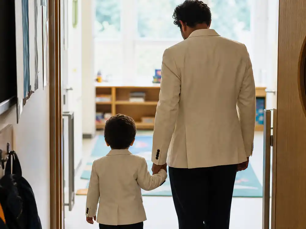 Matching cream blazers on father and toddler son silhouettes from behind for celebrity sons who look like their dads RZA Riot Rihanna A Rocky R-initial tradition