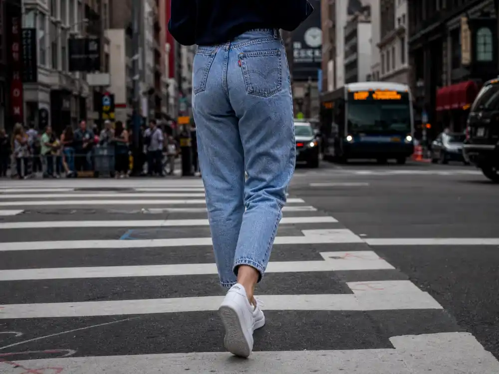High-waist vintage straight-leg jeans and pristine white leather sneakers defining celebrity street style denim and sneaker rotation