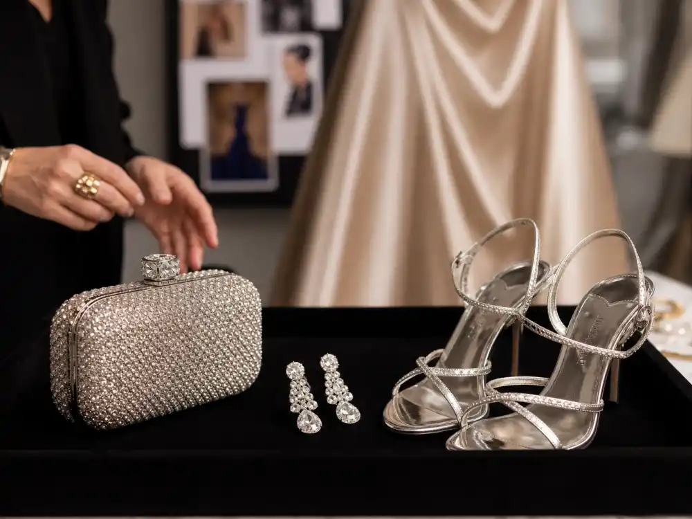 Velvet tray with crystal clutch diamond drop earrings and strappy silver heels laid out for celebrity stylist secrets red carpet accessory selection before premiere