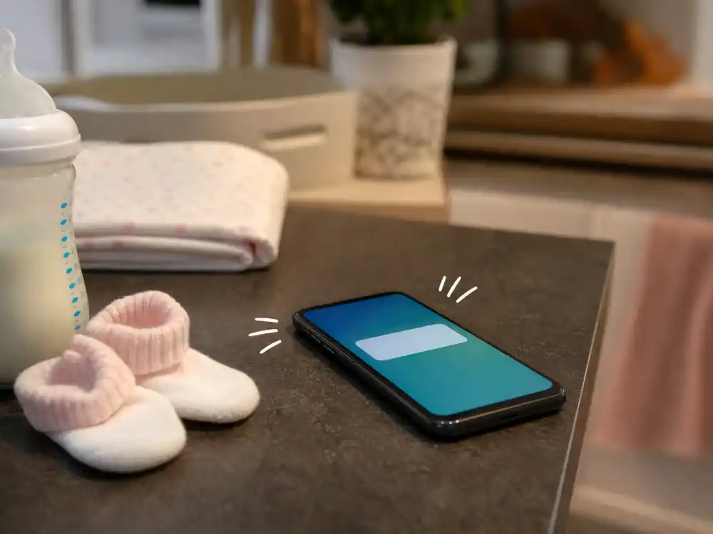 Smartphone notification beside baby bottle for celebrity surprise baby announcements 2025 — midnight Instagram drops that shocked fans without prior bump photos