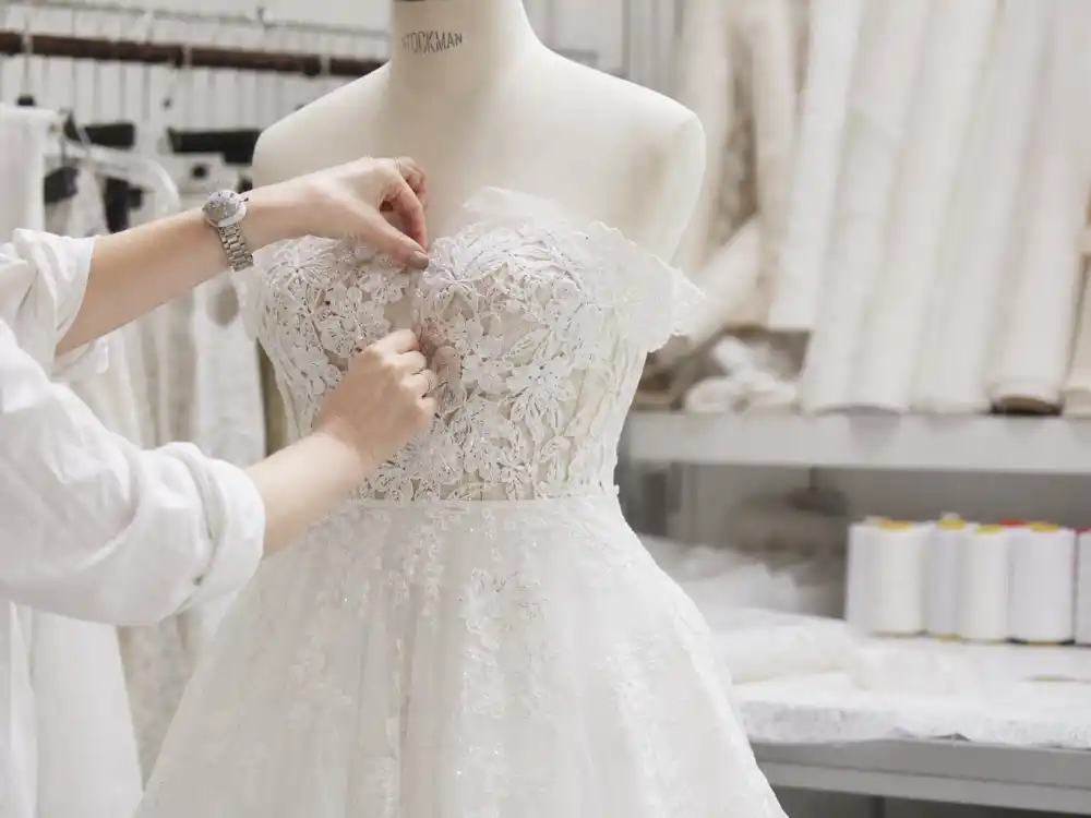 Haute couture bridal atelier workspace central to celebrity wedding dress designers guide with lace swatches and dress forms