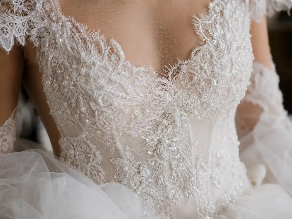 Hand-stitched lace and pearl embroidery couture detail defining celebrity wedding dress designers guide craftsmanship standards