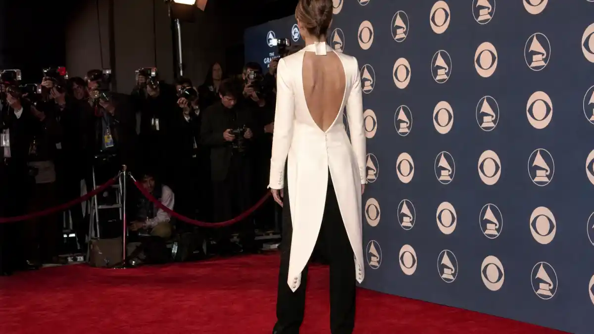 Celine Dion reverse tuxedo Grammys — iconic white tailcoat worn backwards with tails facing forward photographed from behind on 1999 Grammy Awards red carpet